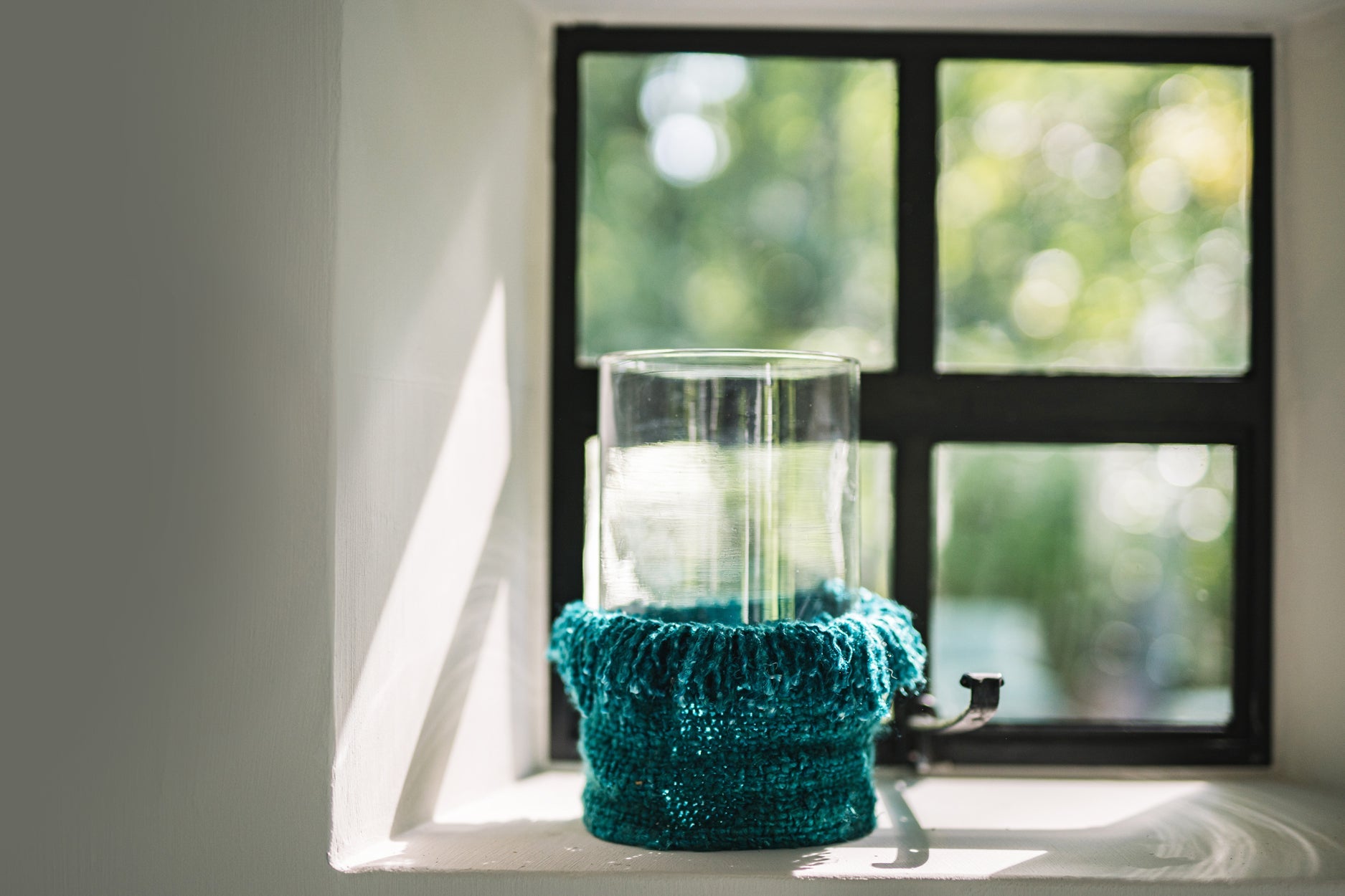 Kerzenhalter aus Glas in Türkis mit XXL-Baumwollfransen