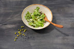 Bol de salade verte fraîche avec une cuillère en racine de teck finition naturelle