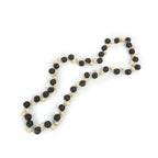 Guirlande murale en perles de bois noir et naturel torsadées