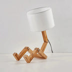 Vue de côté de la lampe de chevet bonhomme en bois avec abat-jour blanc