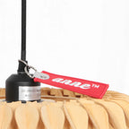 Luminaire suspendu en bois naturel design ondulé avec étiquette rouge, Ø46 cm