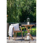 Table ronde en teck naturel Ø70 cm avec lanternes en verre
